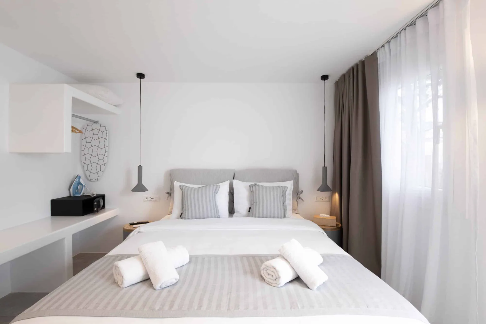Double Room with Patio · Queen-size bed with striped cushions